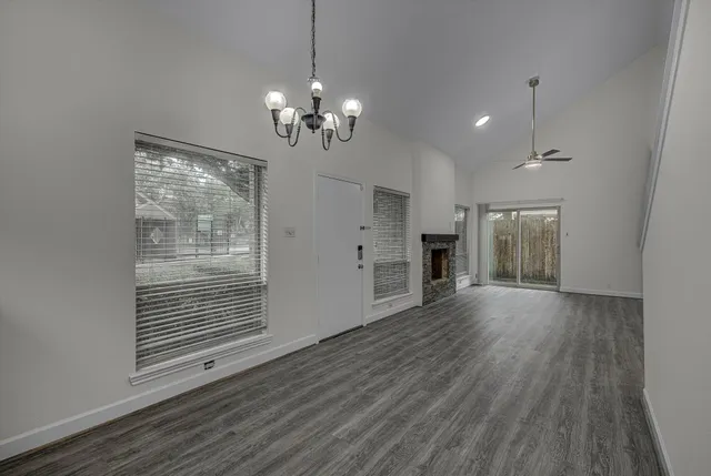 a view of a livingroom with wooden floor and a ceiling fan