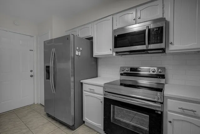 a kitchen with stainless steel appliances and wooden cabinets