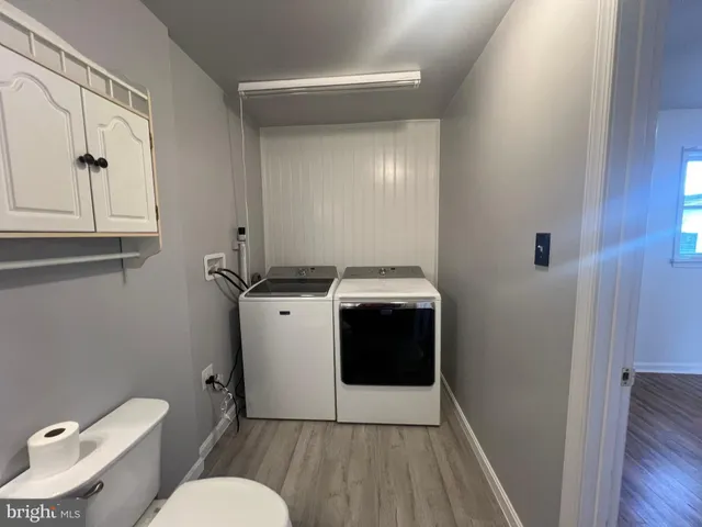 a bathroom with a granite countertop toilet sink and mirror