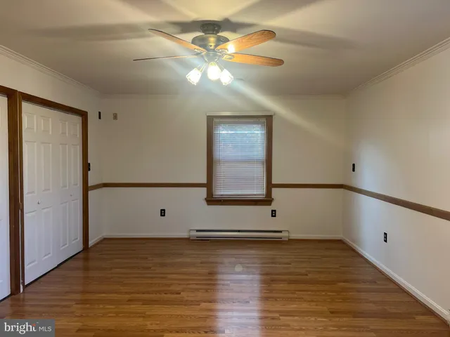a view of room with window and hardwood floor