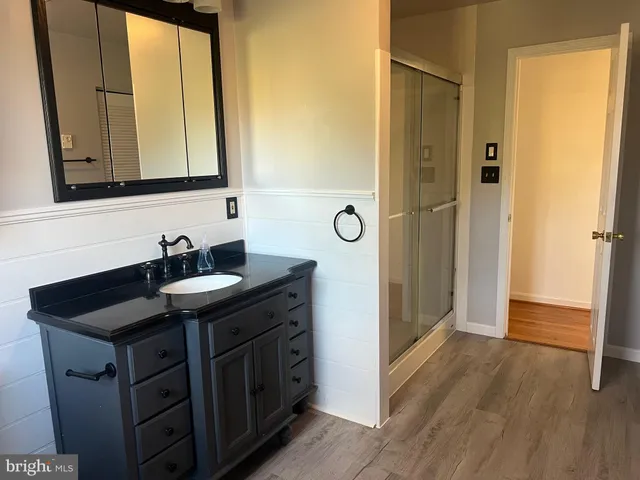 a kitchen with a sink a refrigerator and cabinets