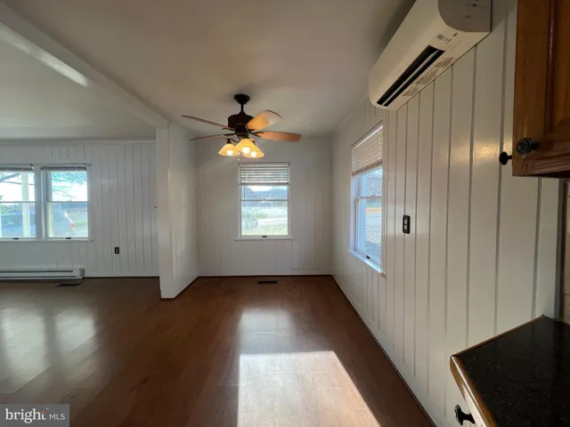wooden floor in an empty room with a window