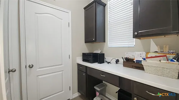 a kitchen with a sink cabinets and a window