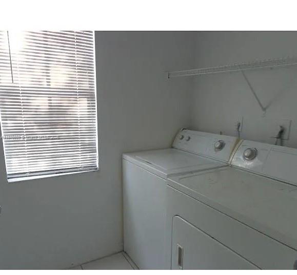 2516 Centergate Drive, Unit 308 Miramar, FL 33025 - Photo 12 of 16 a utility room with dryer and washer