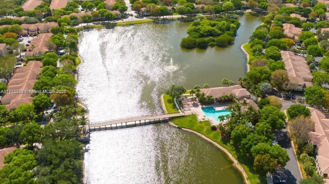 an aerial view of a house with a yard and lake view