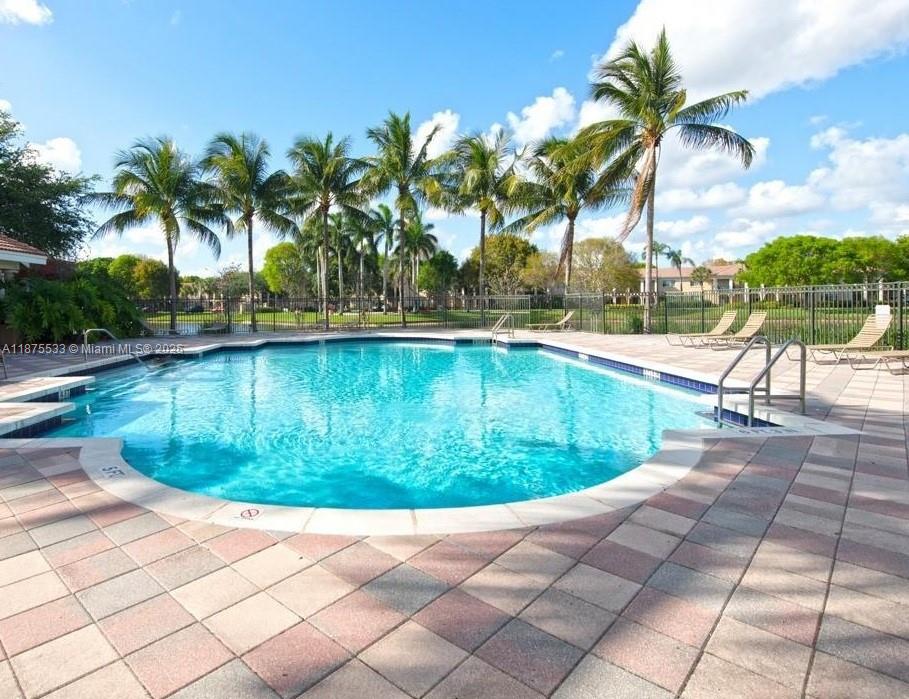 2516 Centergate Drive, Unit 308 Miramar, FL 33025 - Photo 15 of 16 a view of a swimming pool with a yard