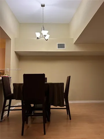 a view of a dining room with furniture and chandelier