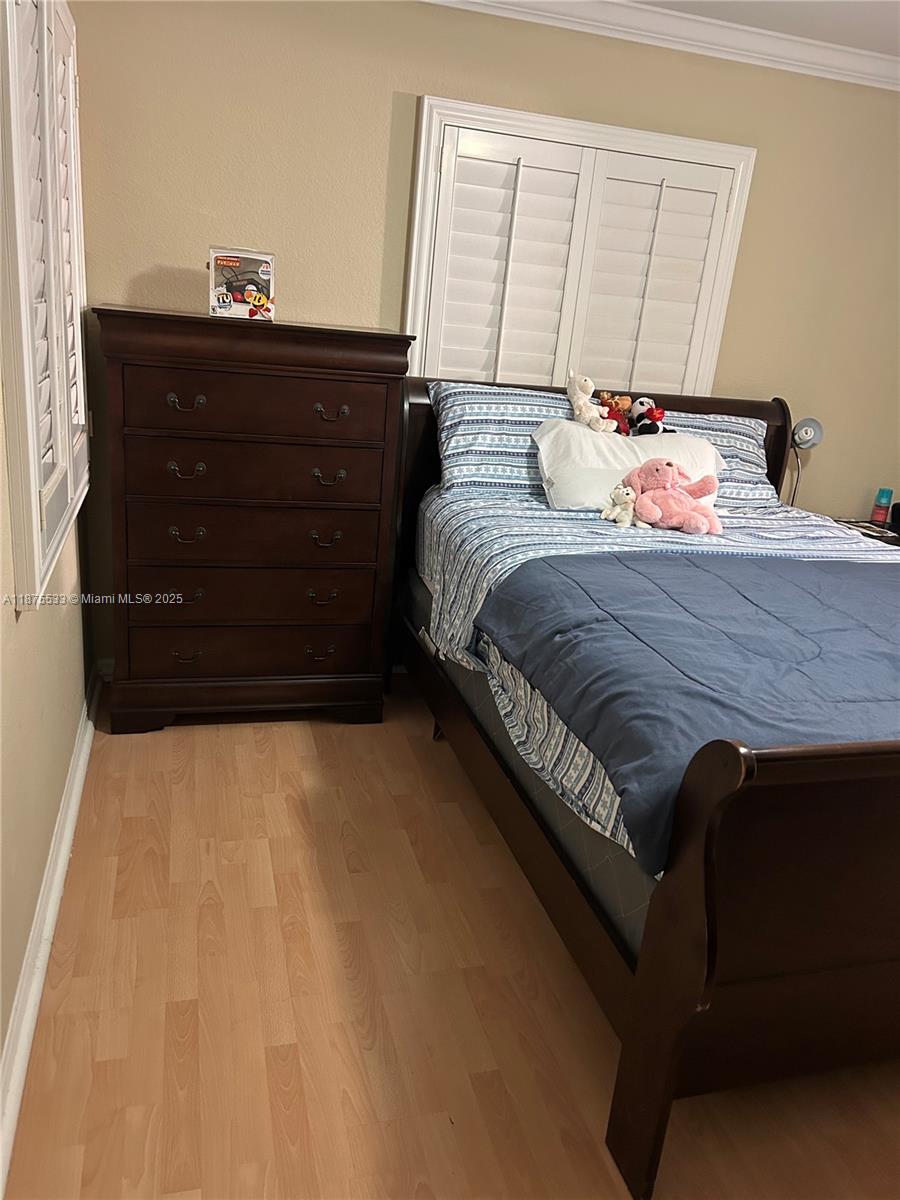 2516 Centergate Drive, Unit 308 Miramar, FL 33025 - Photo 6 of 16 a bedroom with a bed and a dresser