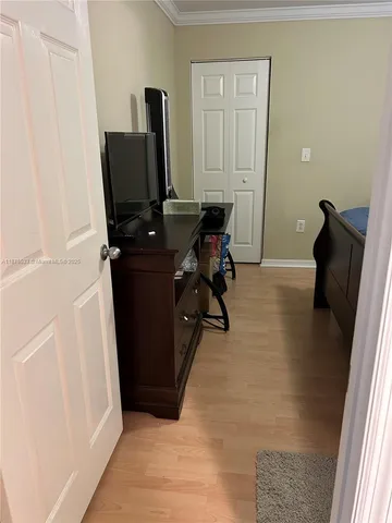 a view of a workspace with furniture and wooden floor
