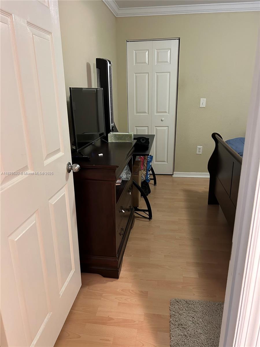 2516 Centergate Drive, Unit 308 Miramar, FL 33025 - Photo 7 of 16 a view of a workspace with furniture and wooden floor