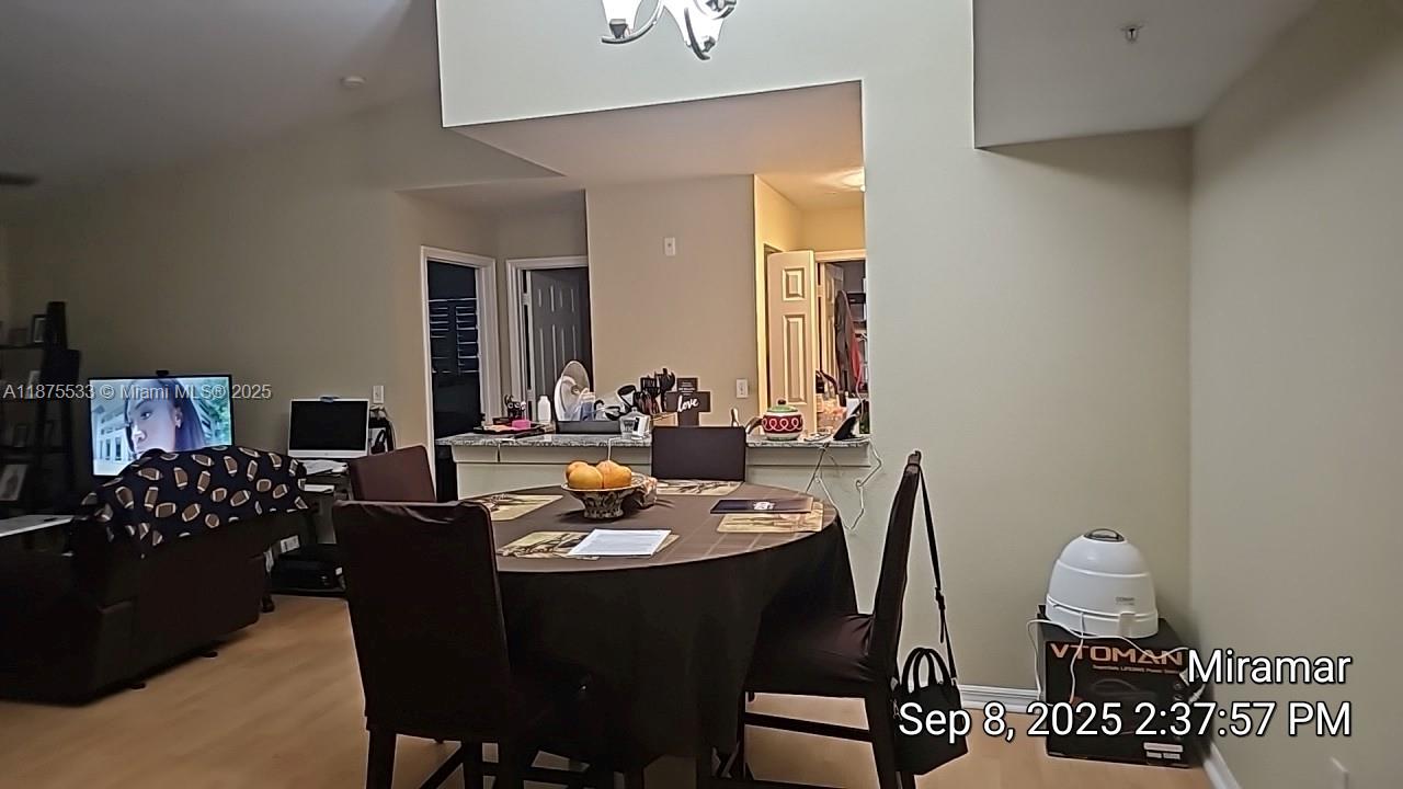 2516 Centergate Drive, Unit 308 Miramar, FL 33025 - Photo 10 of 16 a view of a dining room with furniture and chandelier