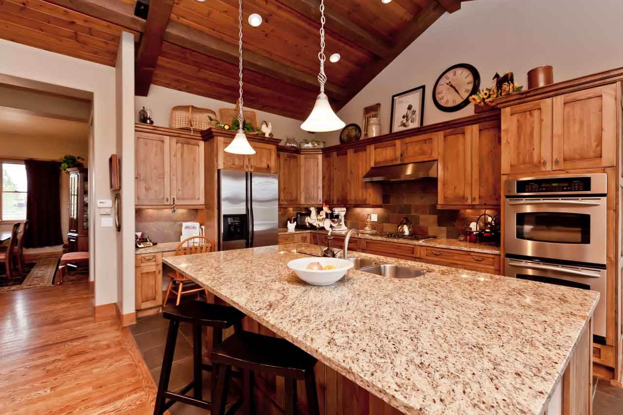 1355 Saddle Ridge Road Loma, CO 81524 - Photo 22 of 36 a kitchen with stainless steel appliances granite countertop a table chairs and a refrigerator