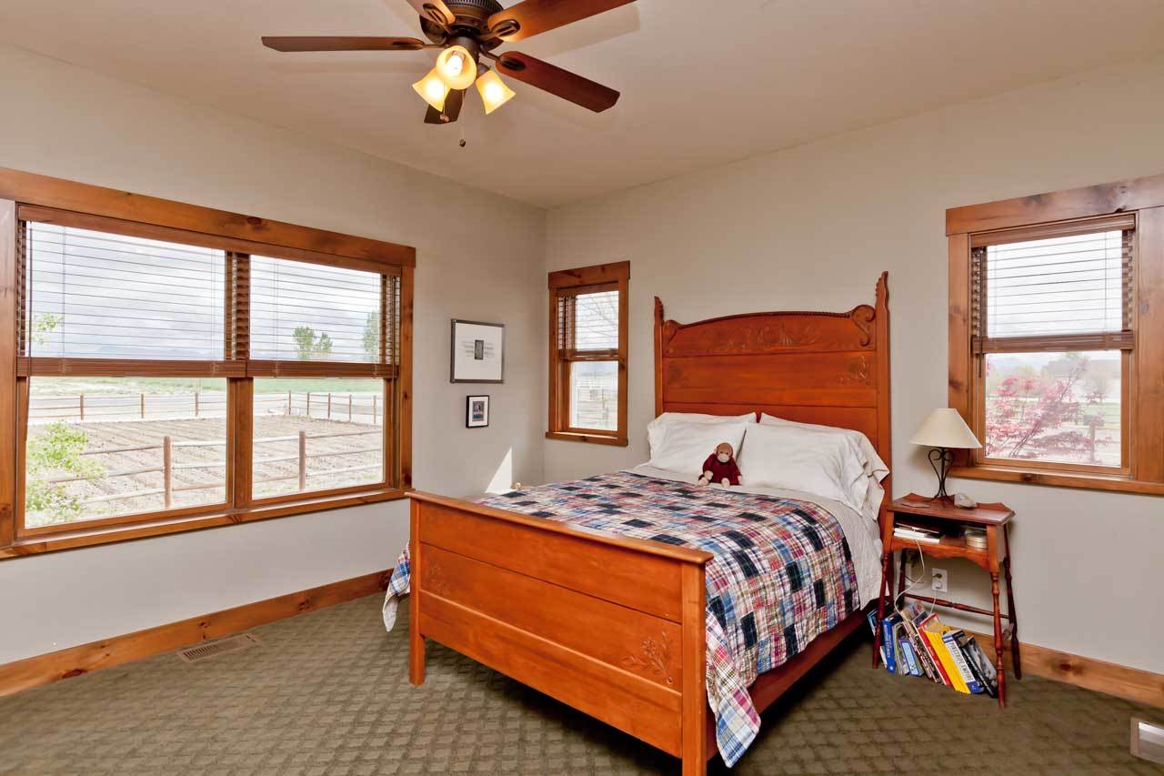 1355 Saddle Ridge Road Loma, CO 81524 - Photo 27 of 36 a bedroom with a bed and window