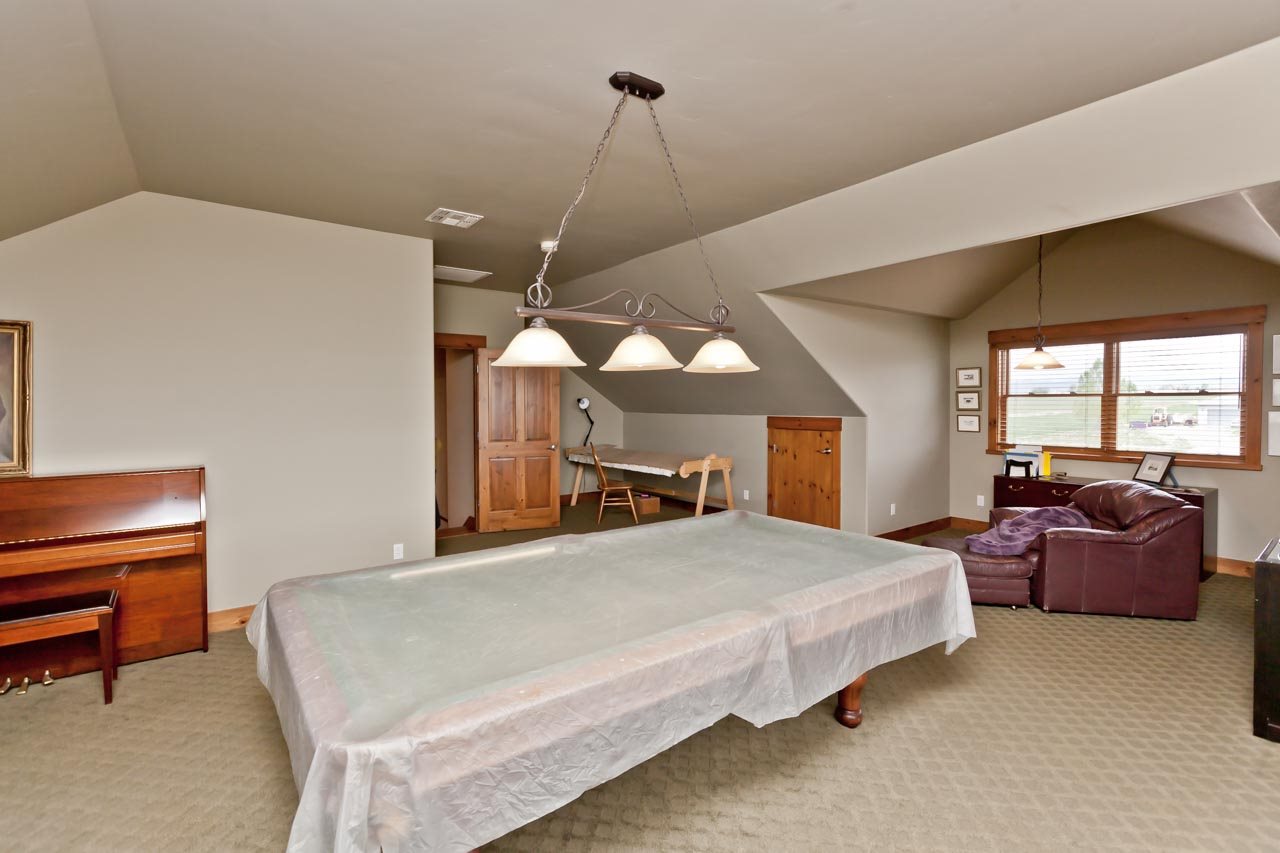 1355 Saddle Ridge Road Loma, CO 81524 - Photo 28 of 36 a bedroom with a bed and a couch