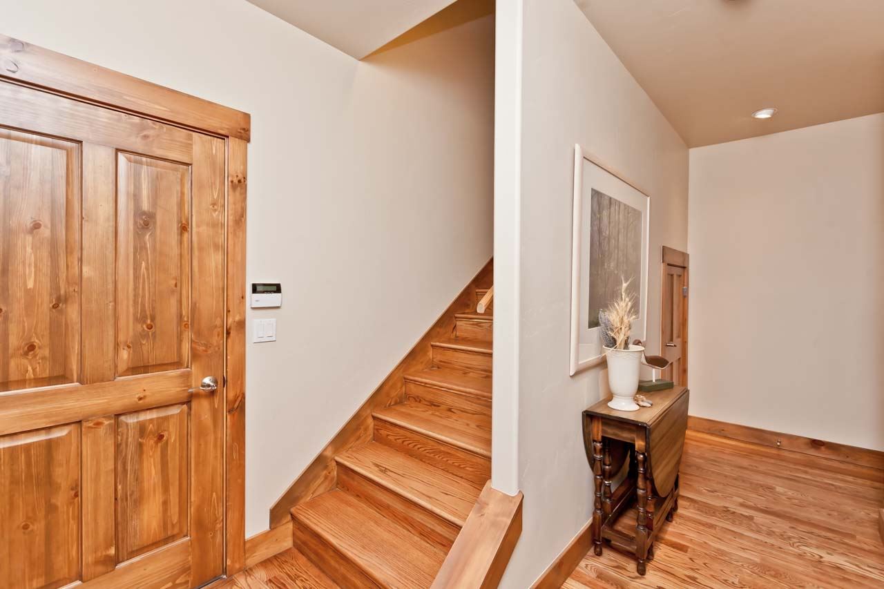 1355 Saddle Ridge Road Loma, CO 81524 - Photo 30 of 36 a view of a hallway with wooden floor and staircase