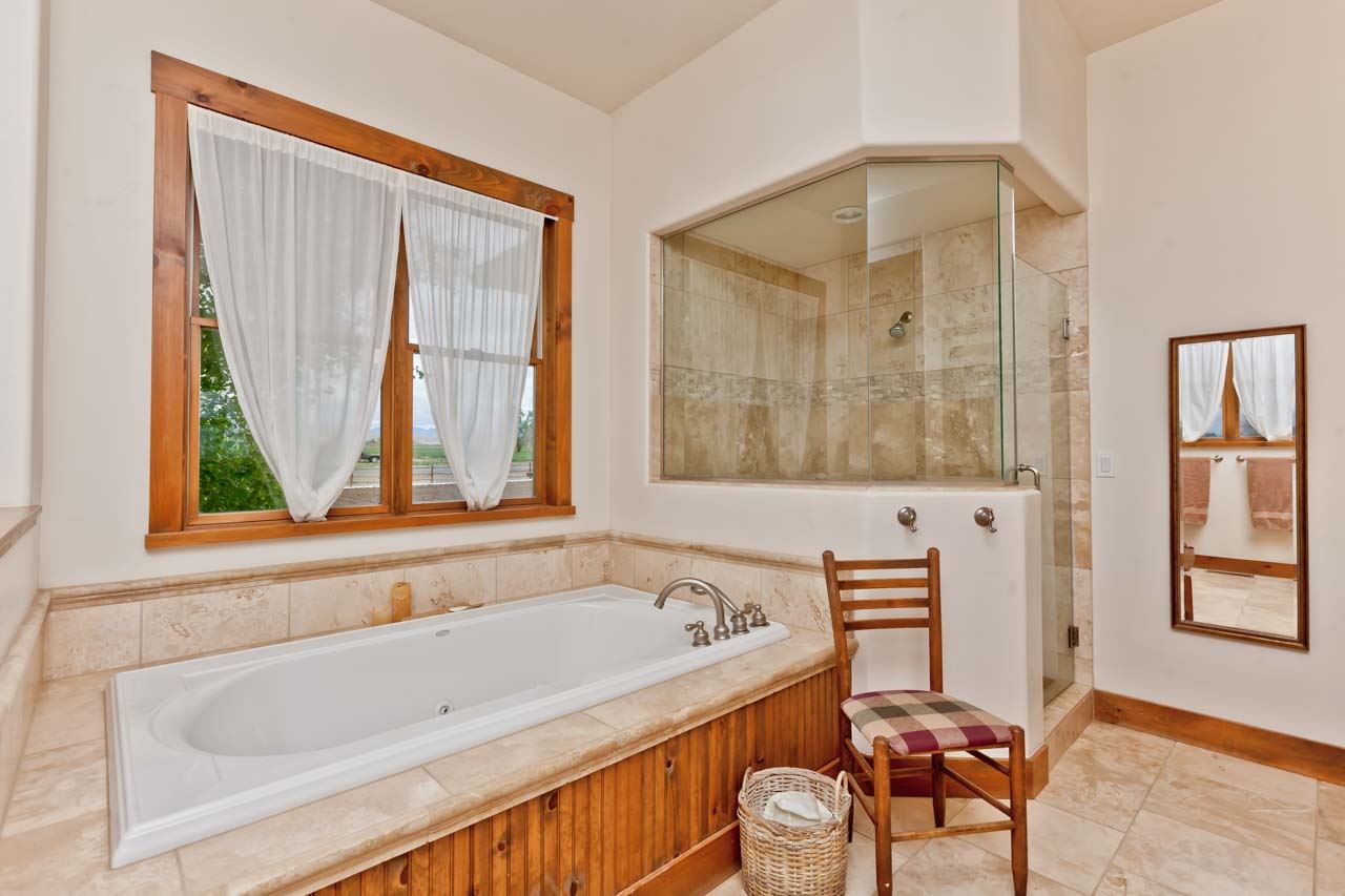 1355 Saddle Ridge Road Loma, CO 81524 - Photo 3 of 36 a bathroom with a bathtub and a window