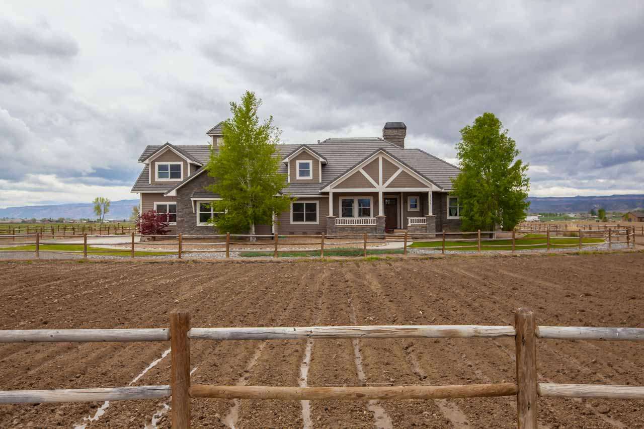 1355 Saddle Ridge Road Loma, CO 81524 - Photo 36 of 36 a front view of a house with a yard
