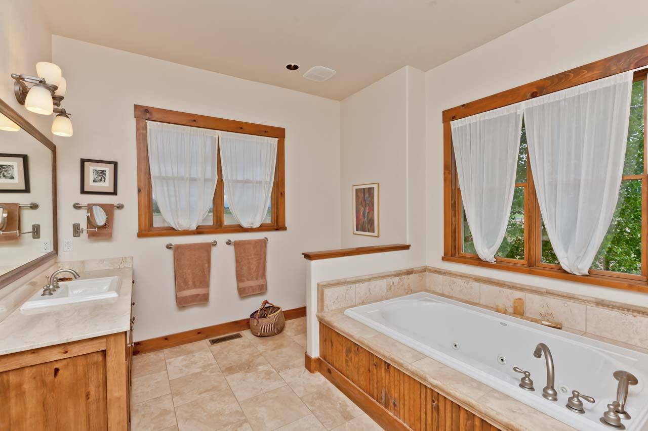 1355 Saddle Ridge Road Loma, CO 81524 - Photo 5 of 36 a bathroom with a tub sink and a window