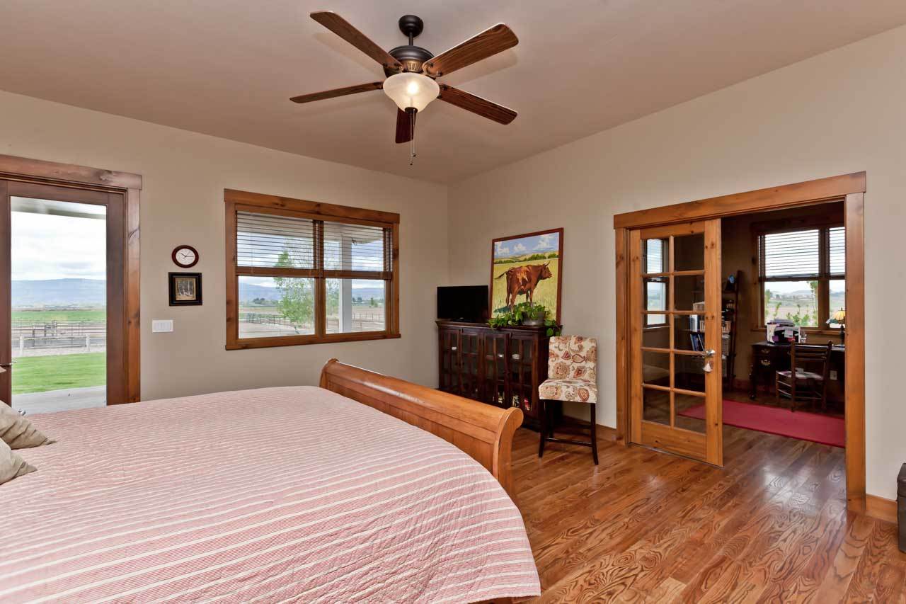 1355 Saddle Ridge Road Loma, CO 81524 - Photo 9 of 36 a bedroom with a bed and wooden floor