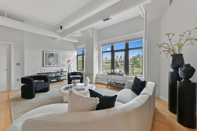 a living room with furniture and a potted plant