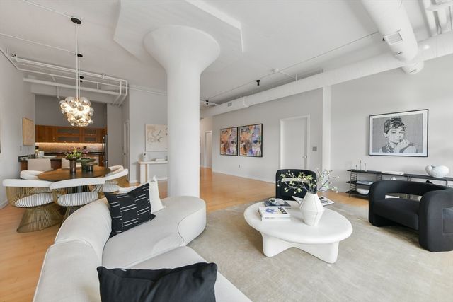 a living room with furniture and a chandelier