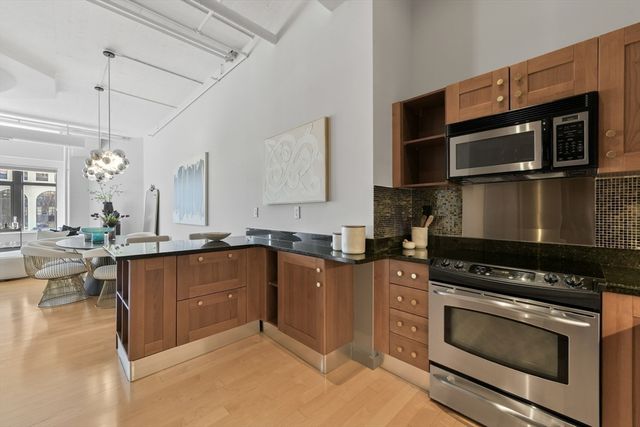 a kitchen with stainless steel appliances a stove a sink and a microwave