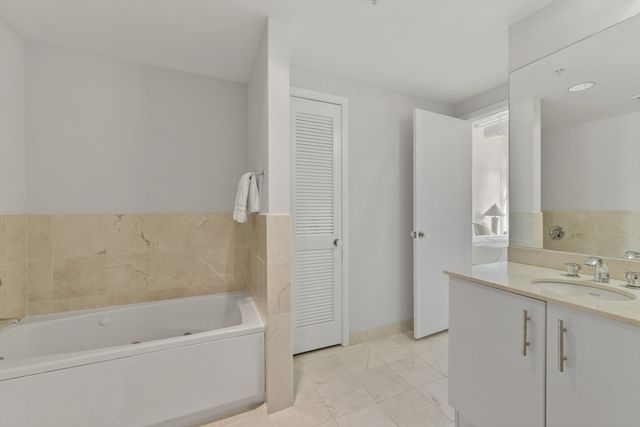 a bathroom with a bathtub and a sink