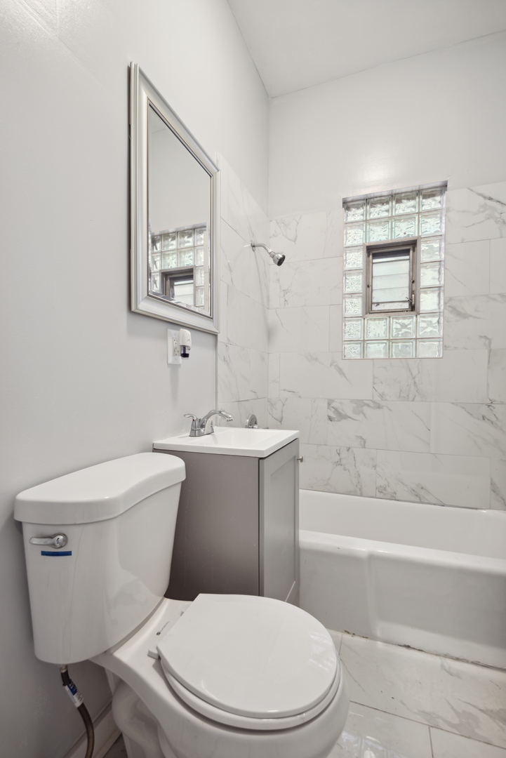 5918 South Carpenter Street Chicago, IL 60621 - Photo 11 of 15 a white toilet sitting next to a bath tub