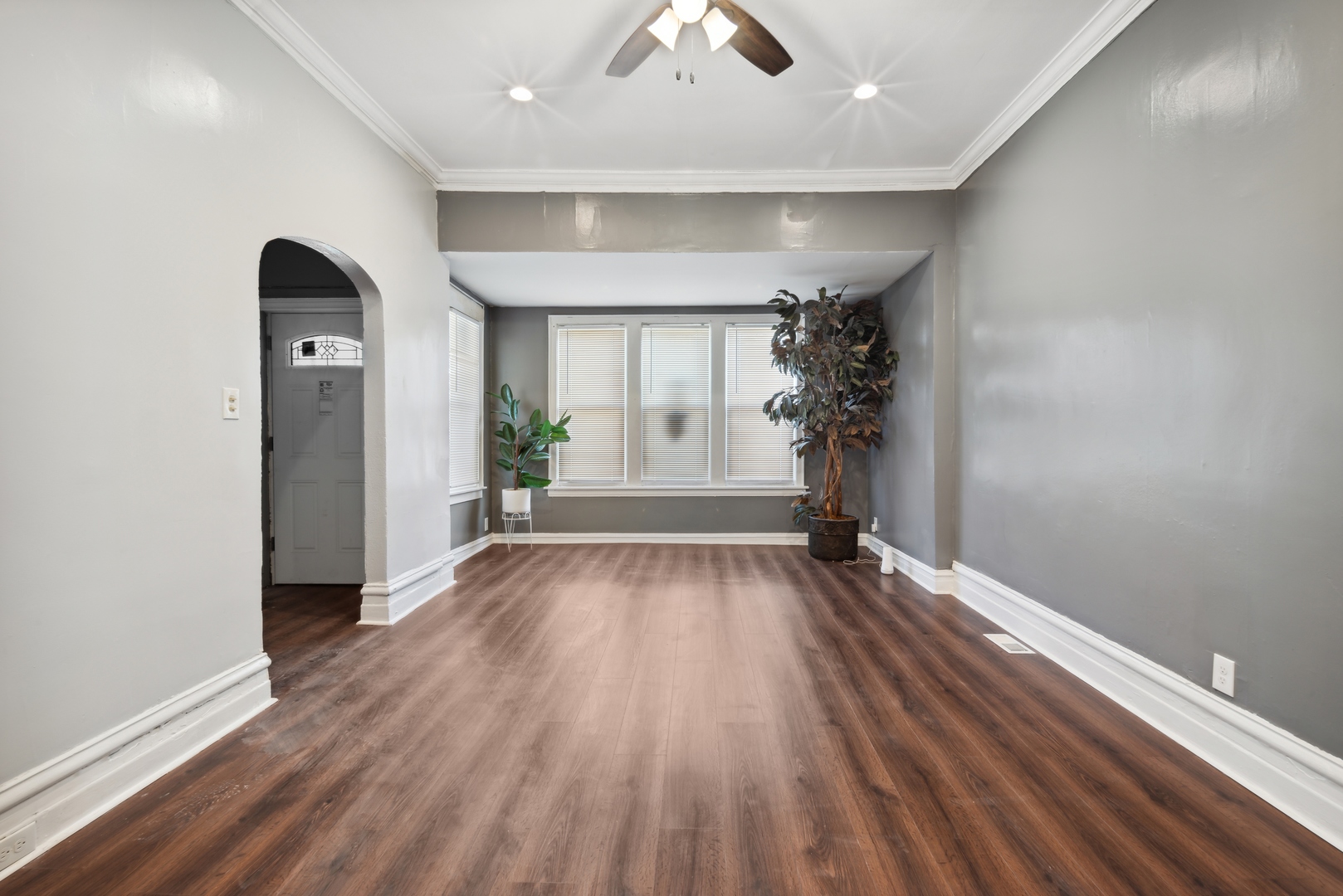 5918 South Carpenter Street Chicago, IL 60621 - Photo 2 of 15 an empty room with wooden floor and windows