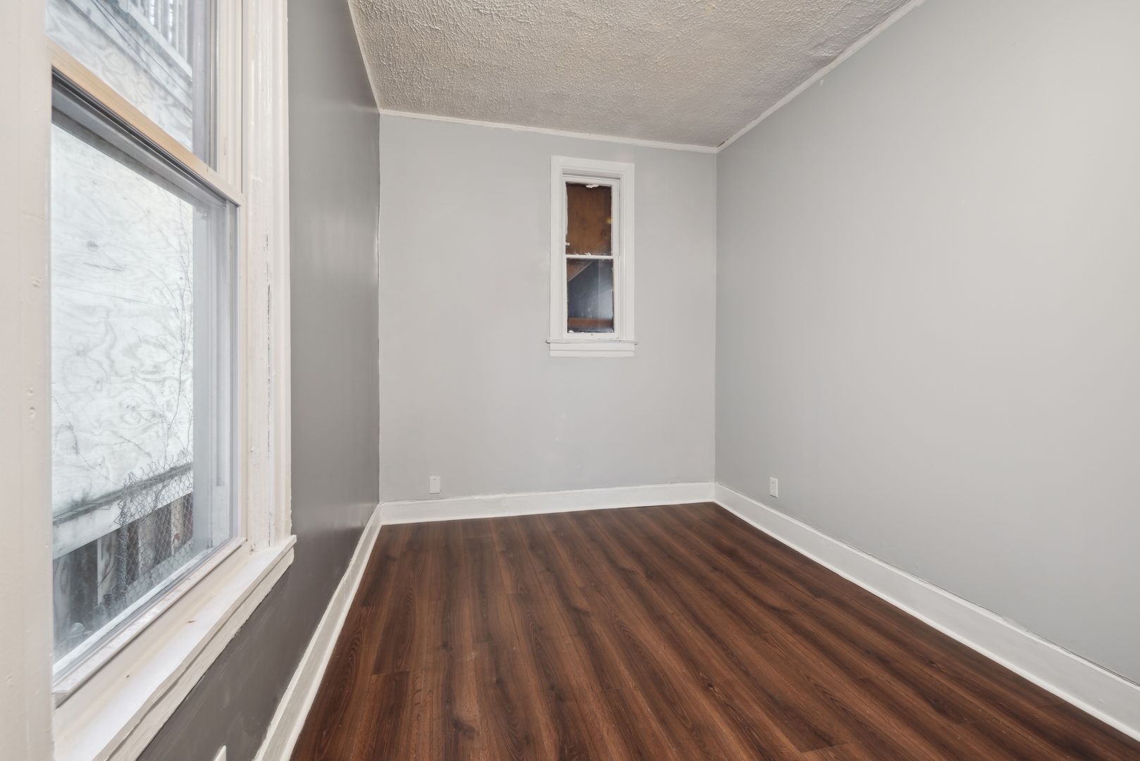 5918 South Carpenter Street Chicago, IL 60621 - Photo 4 of 15 a view of a room with wooden floor and window