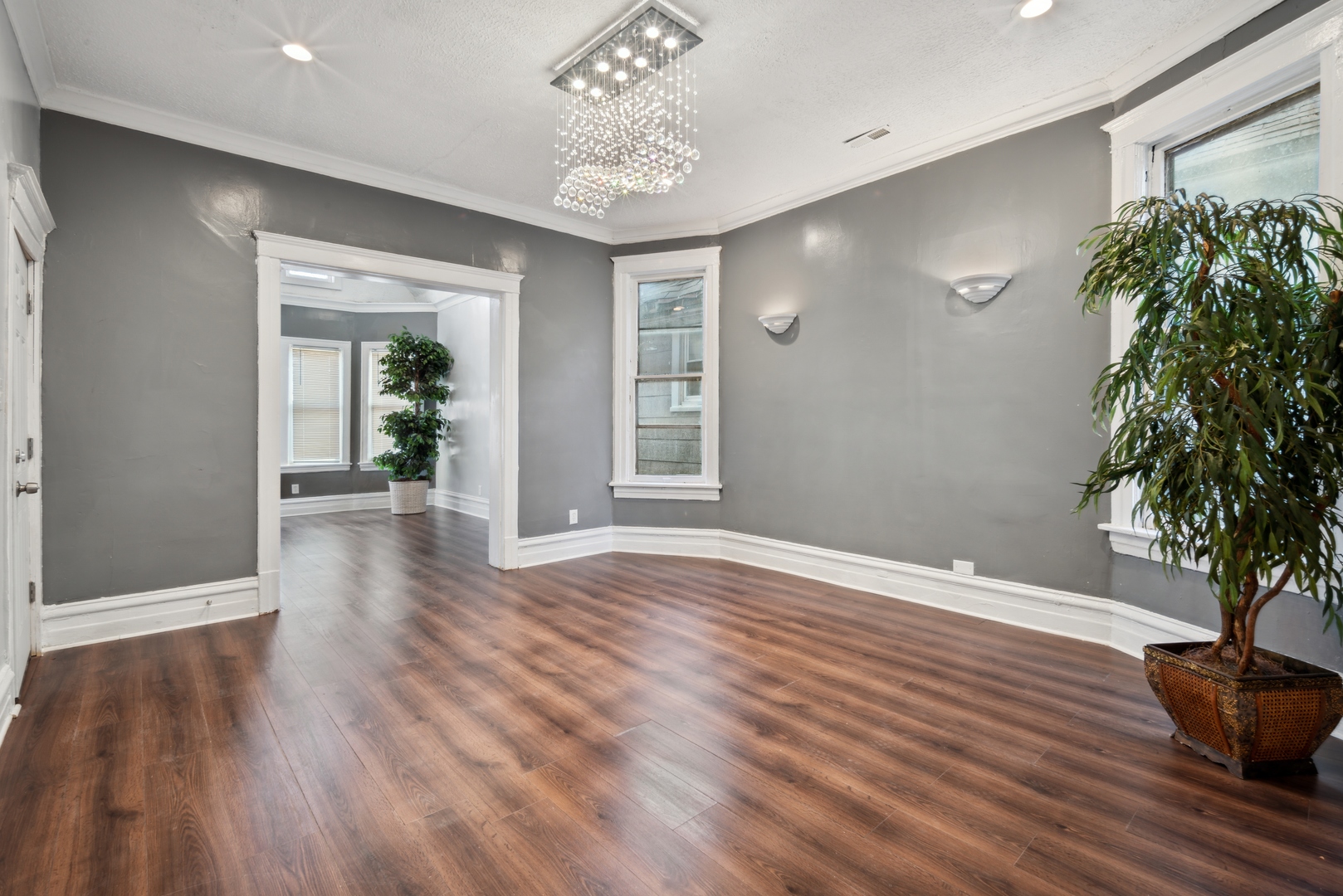 5918 South Carpenter Street Chicago, IL 60621 - Photo 10 of 15 a view of an empty room with wooden floor and a potted plant
