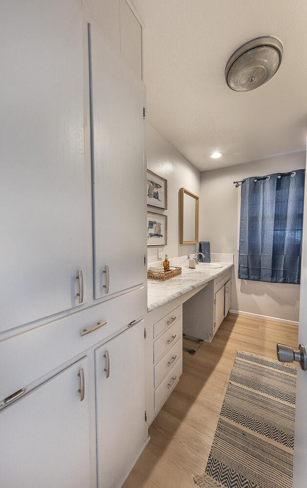 3613 58th Street Lubbock, TX 79413 - Photo 12 of 20 a large white kitchen with a sink and dishwasher with white cabinets