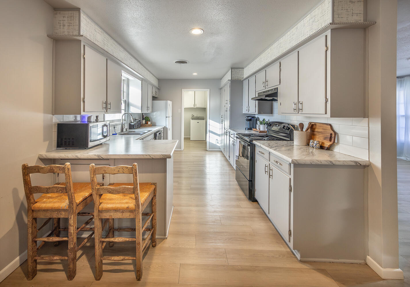 3613 58th Street Lubbock, TX 79413 - Photo 3 of 20 a kitchen with kitchen island granite countertop lots of counter top space and stainless steel appliances
