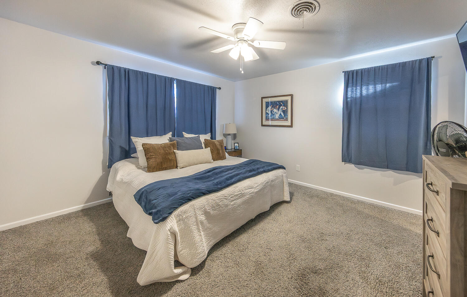 3613 58th Street Lubbock, TX 79413 - Photo 8 of 20 a bedroom with a bed and a chandelier