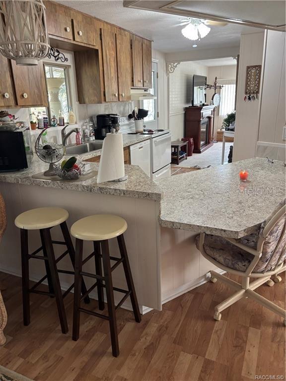 14334 Midfield Street Brooksville, FL 34613 - Photo 12 of 48 a kitchen with kitchen island a table and chairs in it