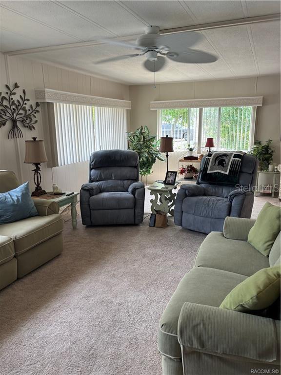 14334 Midfield Street Brooksville, FL 34613 - Photo 15 of 48 a living room with furniture and a large window