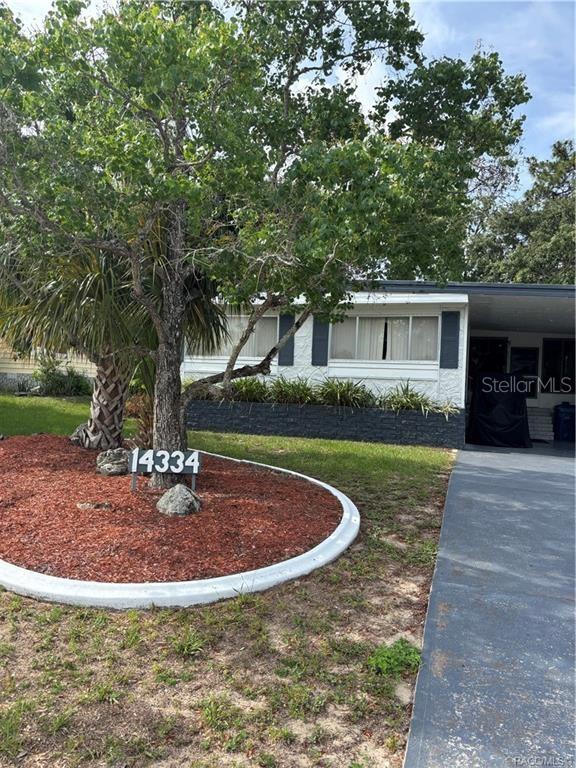 14334 Midfield Street Brooksville, FL 34613 - Photo 2 of 48 a view of a house with a yard