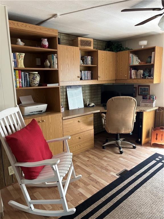 14334 Midfield Street Brooksville, FL 34613 - Photo 21 of 48 a room with furniture and a book shelf