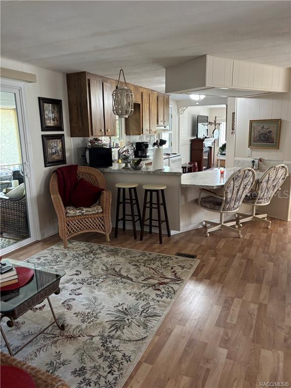 14334 Midfield Street Brooksville, FL 34613 - Photo 24 of 48 a living room with furniture kitchen view and a wooden floor