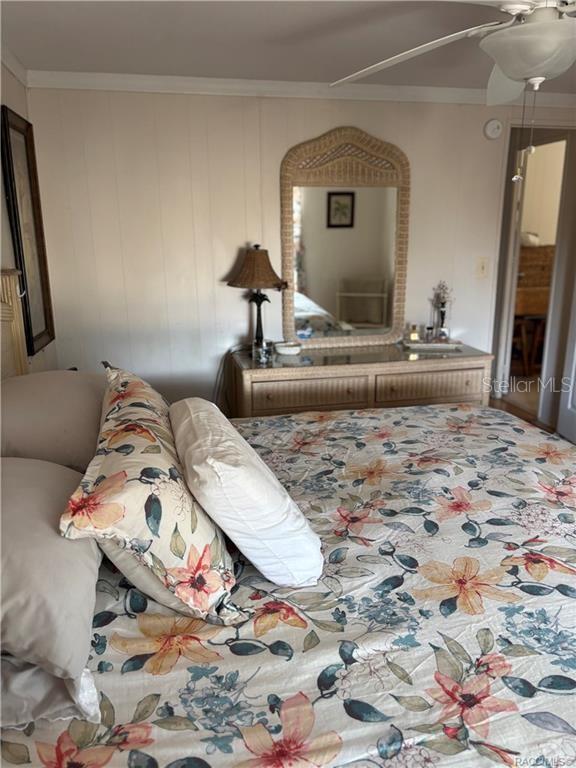 14334 Midfield Street Brooksville, FL 34613 - Photo 34 of 48 a living room with a bed and a mirror