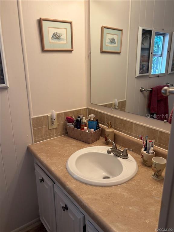 14334 Midfield Street Brooksville, FL 34613 - Photo 36 of 48 a bathroom with a sink and a mirror