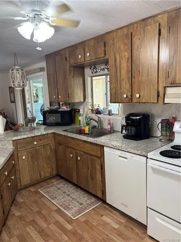 a spacious bathroom with a granite countertop sink a mirror and shower