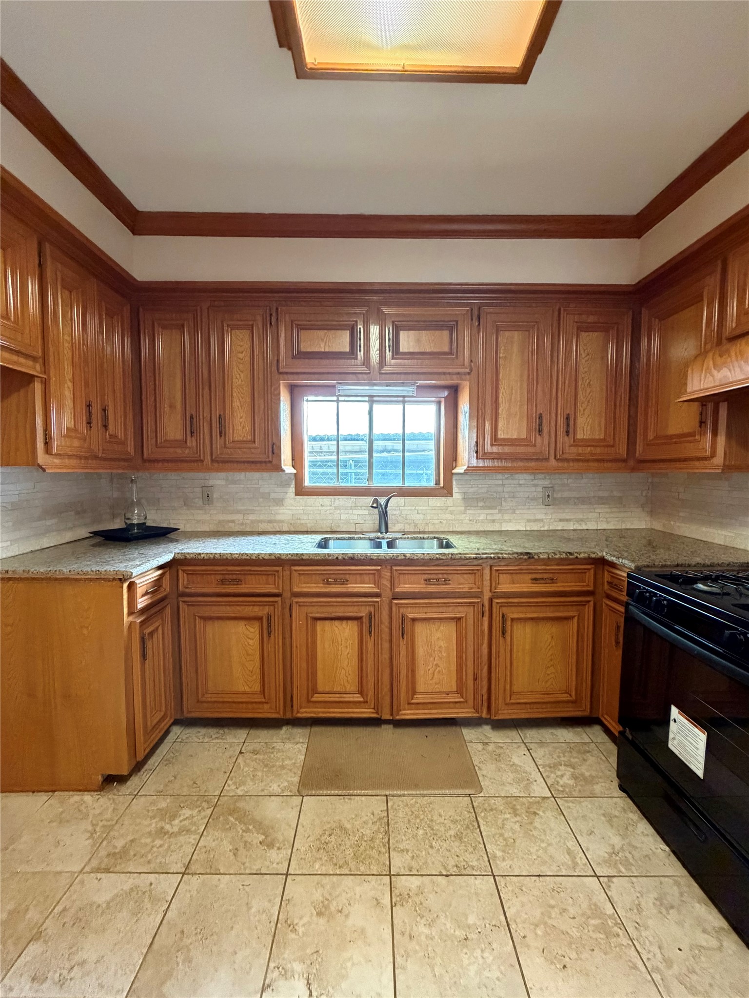 703 76th Street Houston, TX 77012 - Photo 9 of 23 a kitchen with stainless steel appliances granite countertop a stove sink and cabinets