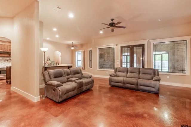 a living room with furniture and kitchen view