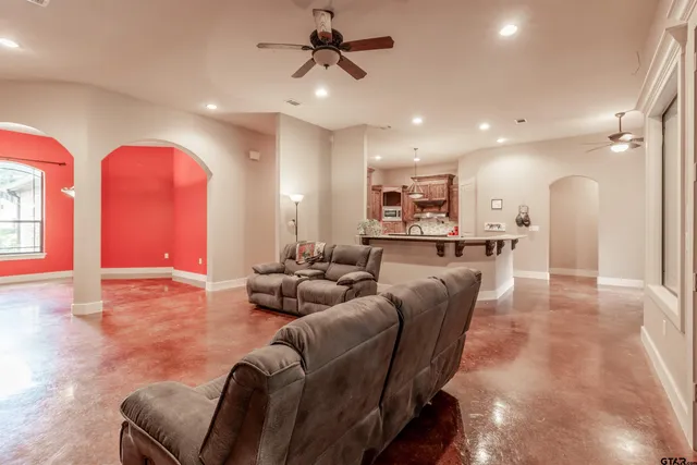 a living room with kitchen island furniture and a kitchen view