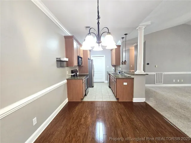 a view of a kitchen with wooden floor