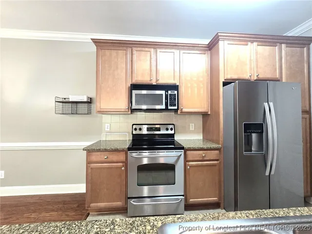 a kitchen with a stove a microwave and refrigerator