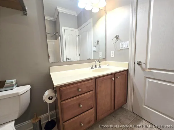 a bathroom with a sink mirror and toilet