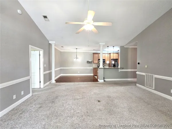 a large white kitchen with a large window
