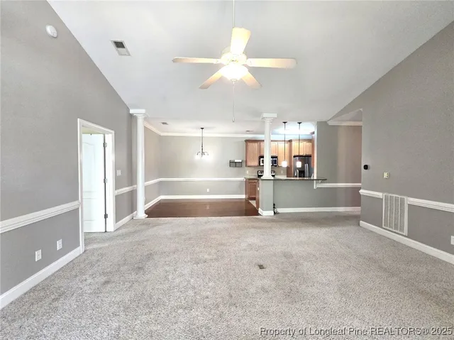 a large white kitchen with a large window